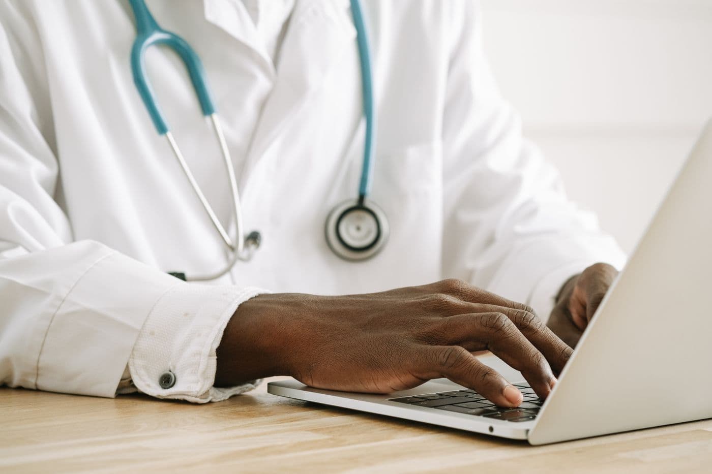 An RN entering assessment findings into the record on a laptop