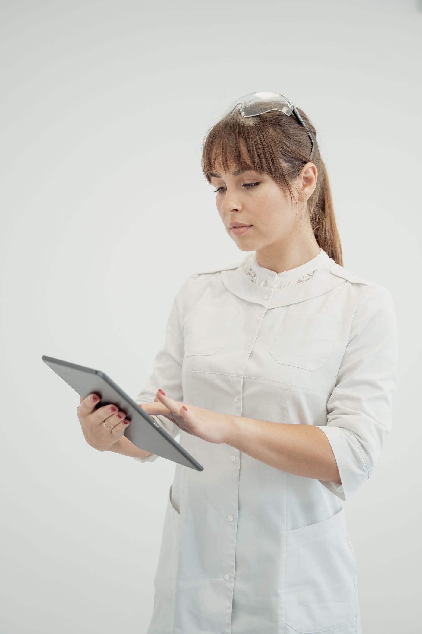 An RN reviewing assessment documentation on a tablet